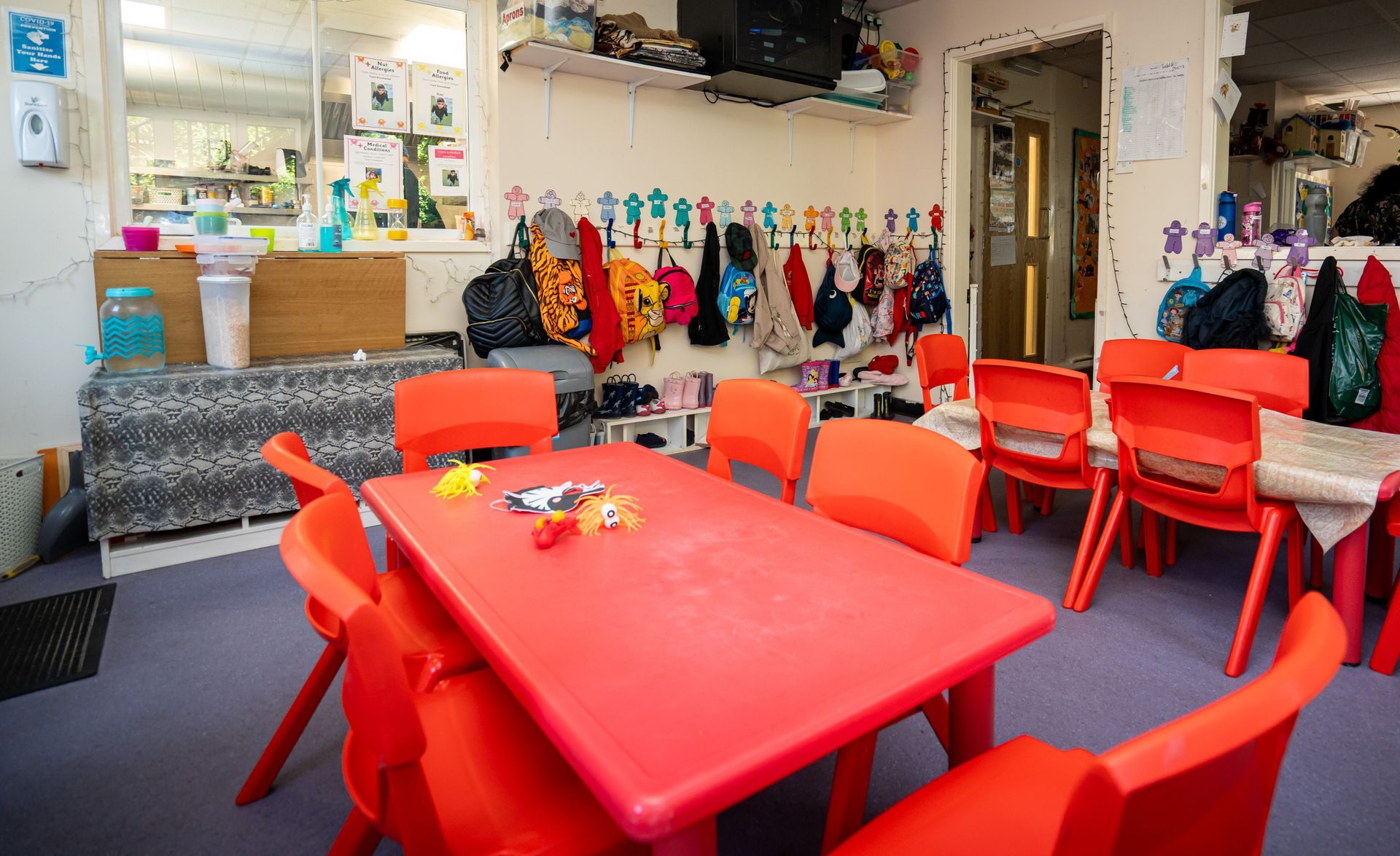 A classroom with red chairs and a red table Gingerbread