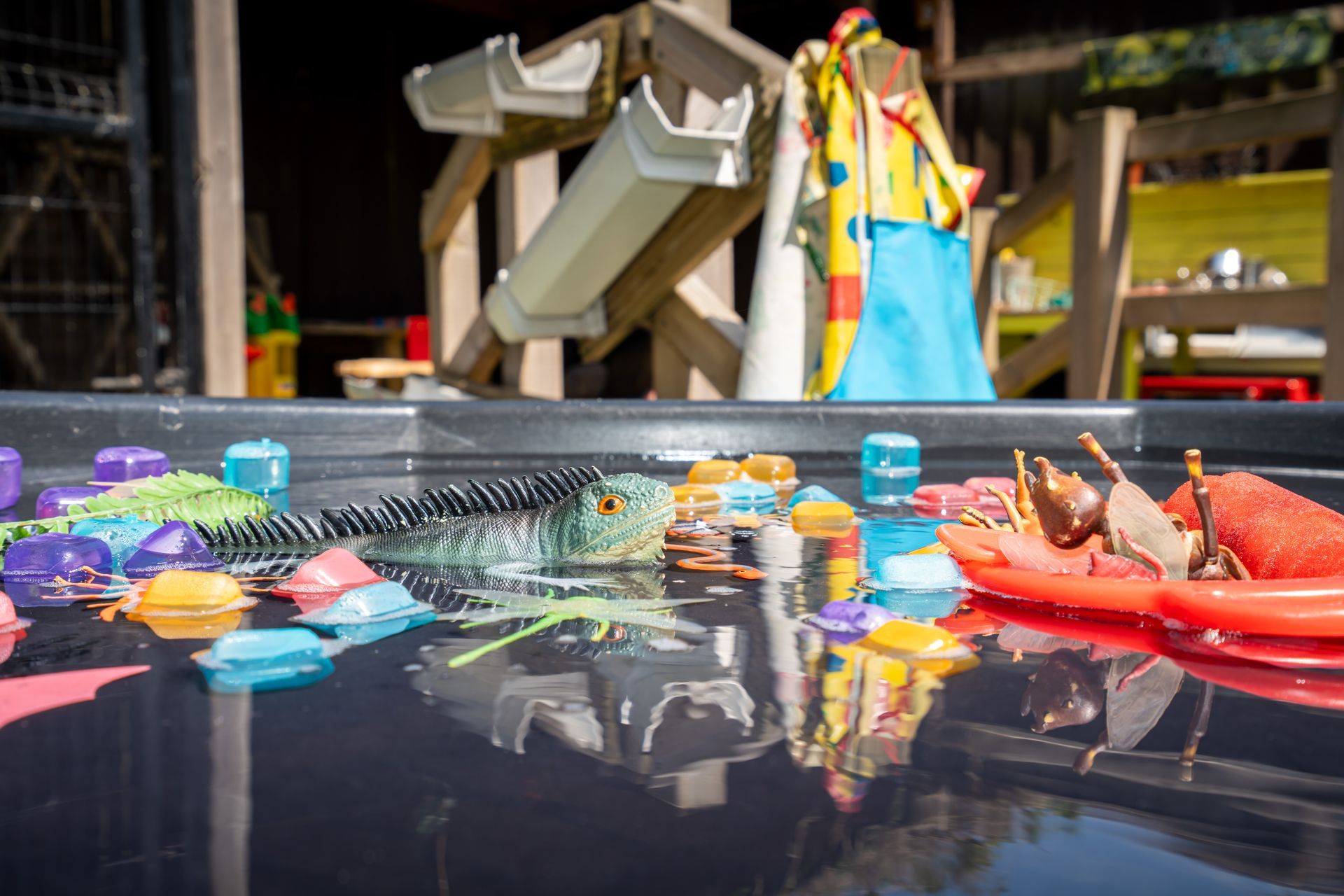 A water table filled with toys and ice cubes. Gingerbread