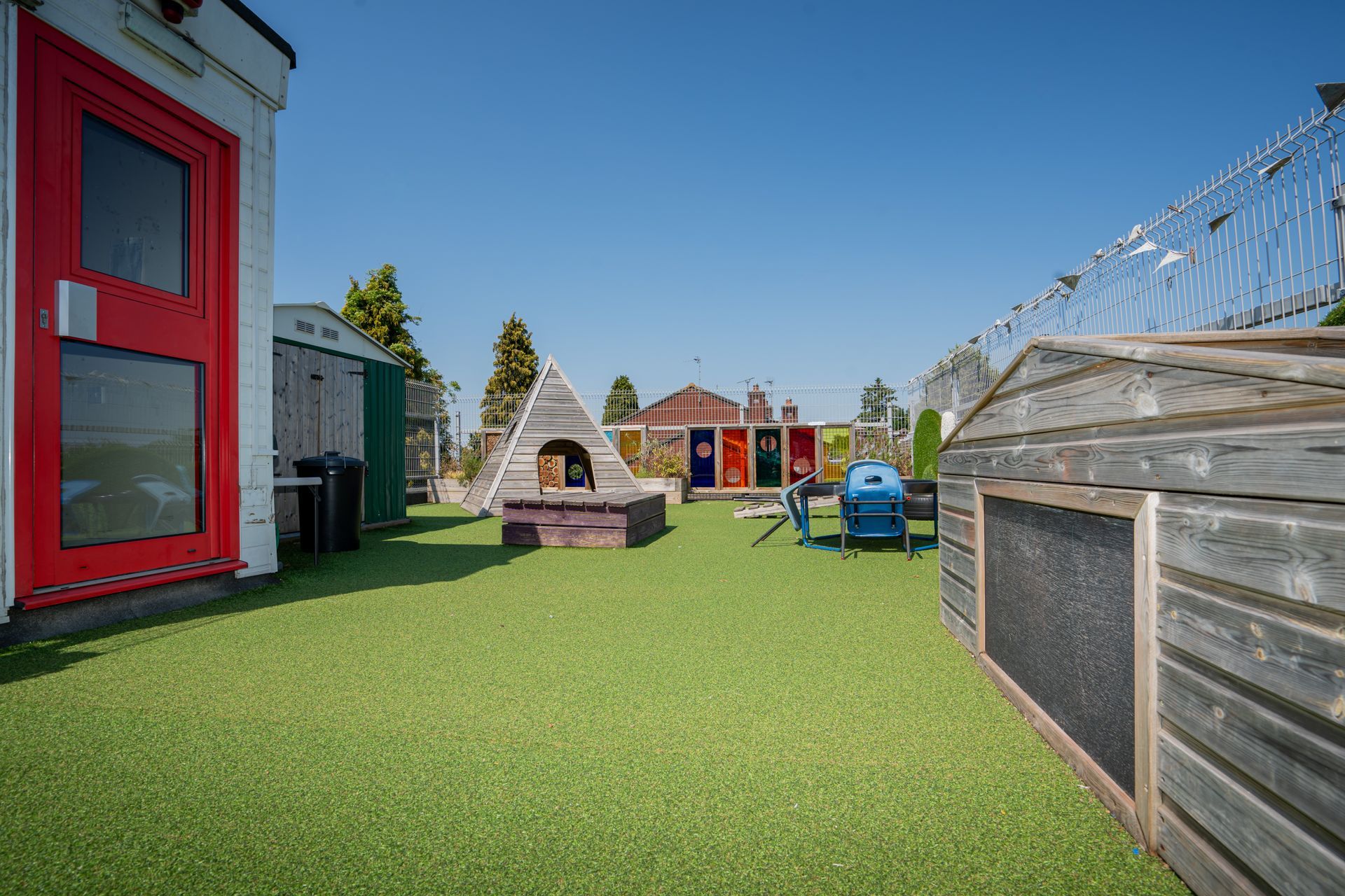 There is a playground in the backyard of a house. Gingerbread