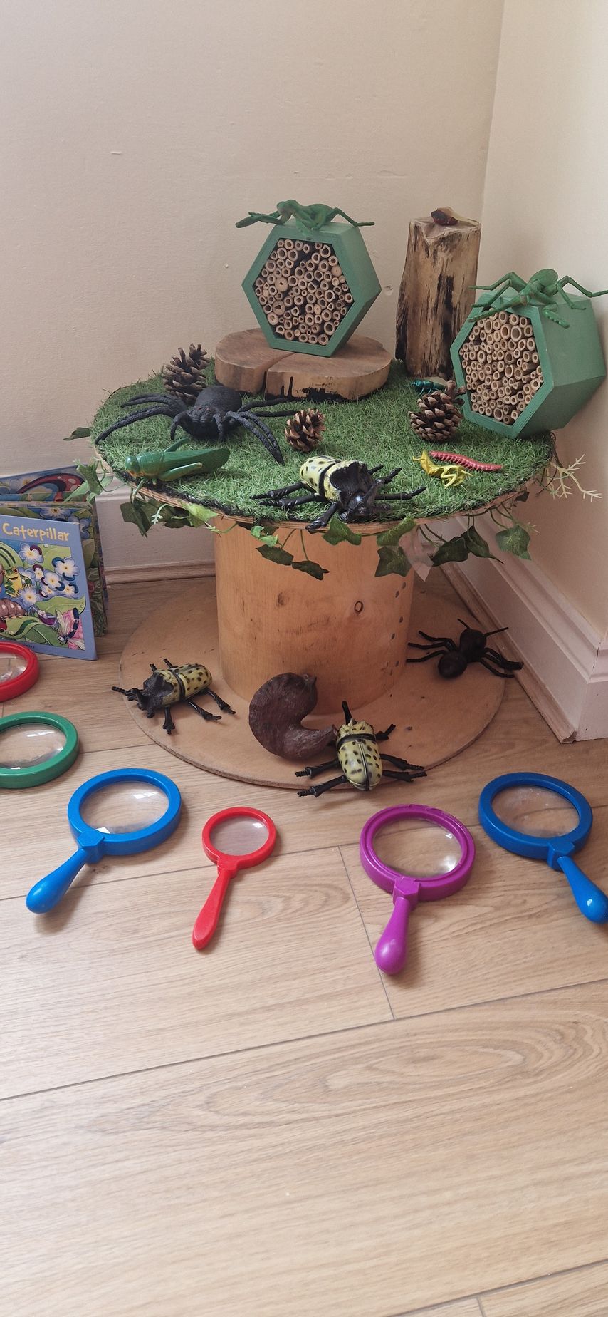 A table with a lot of toys and magnifying glasses on it. Gingerbread