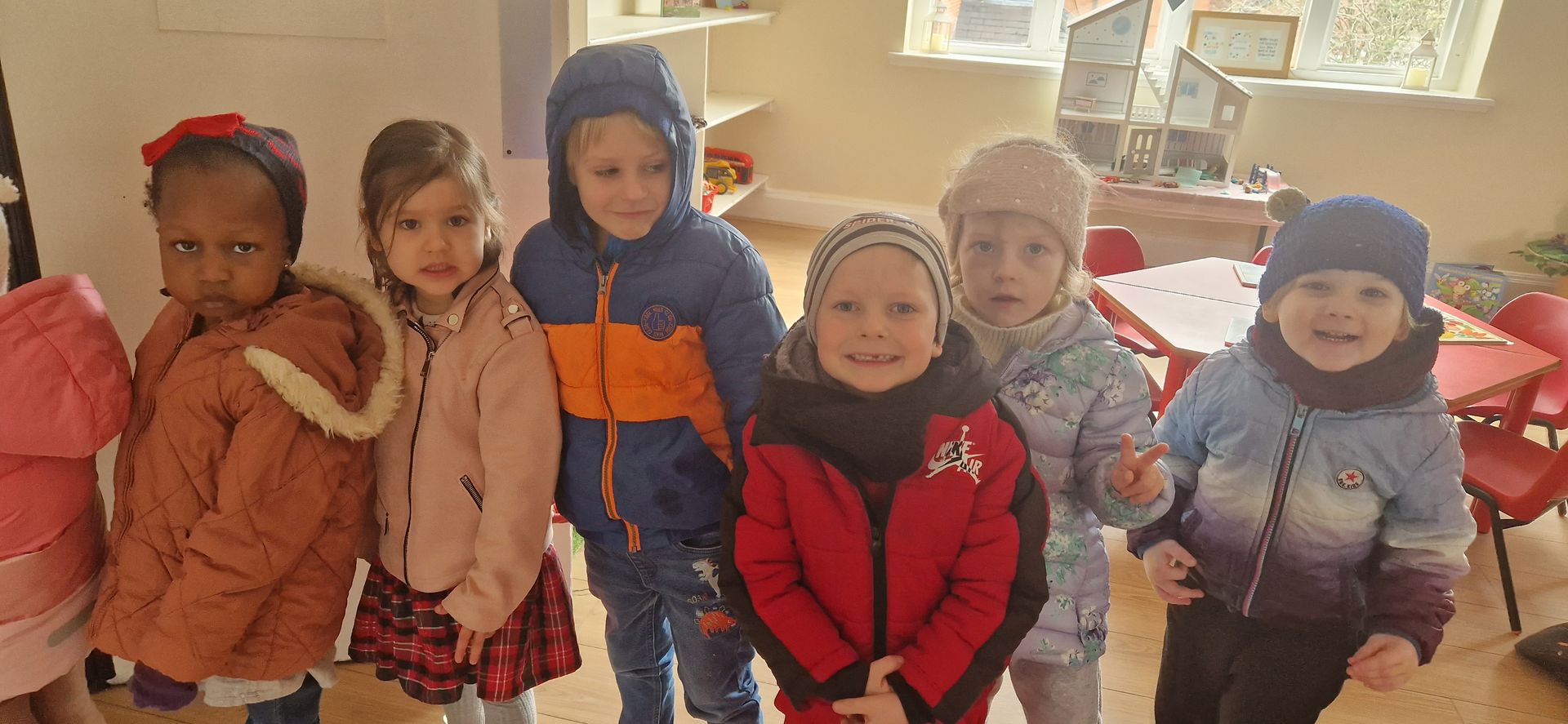 A group of children are standing next to each other in a room. Gingerbread