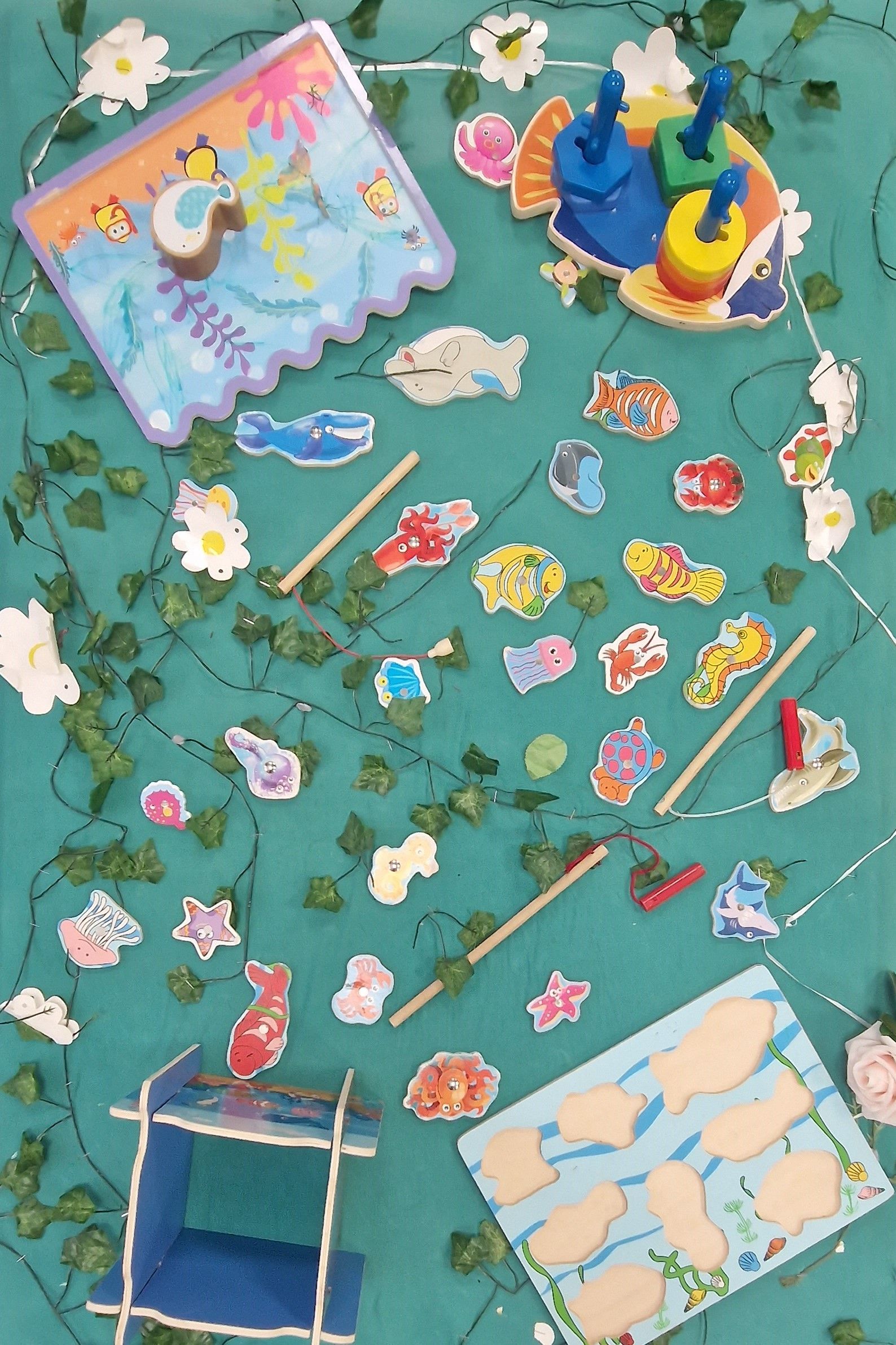 A bunch of toys on a table including a fishing game Gingerbread