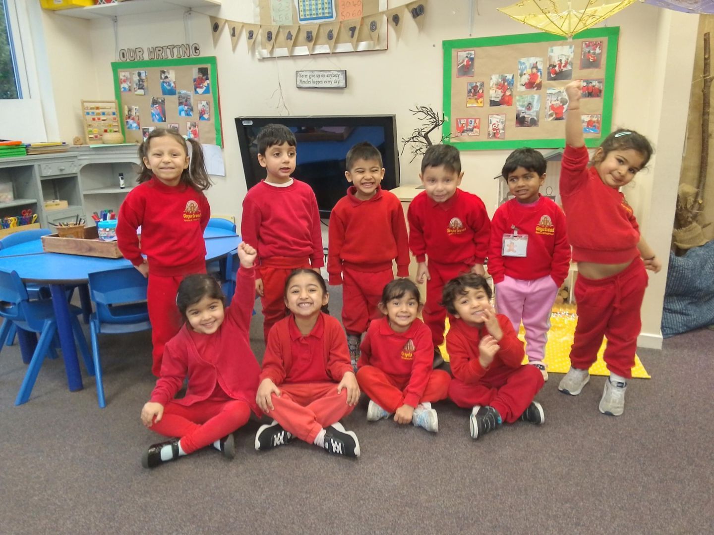 A group of children in red uniforms are posing for a picture Gingerbread