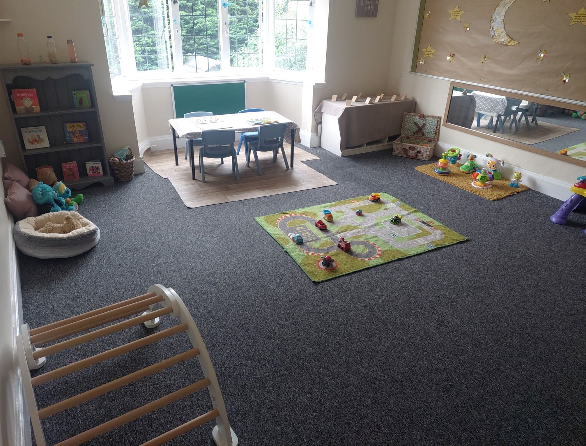 A room filled with toys and a table and chairs. Gingerbread