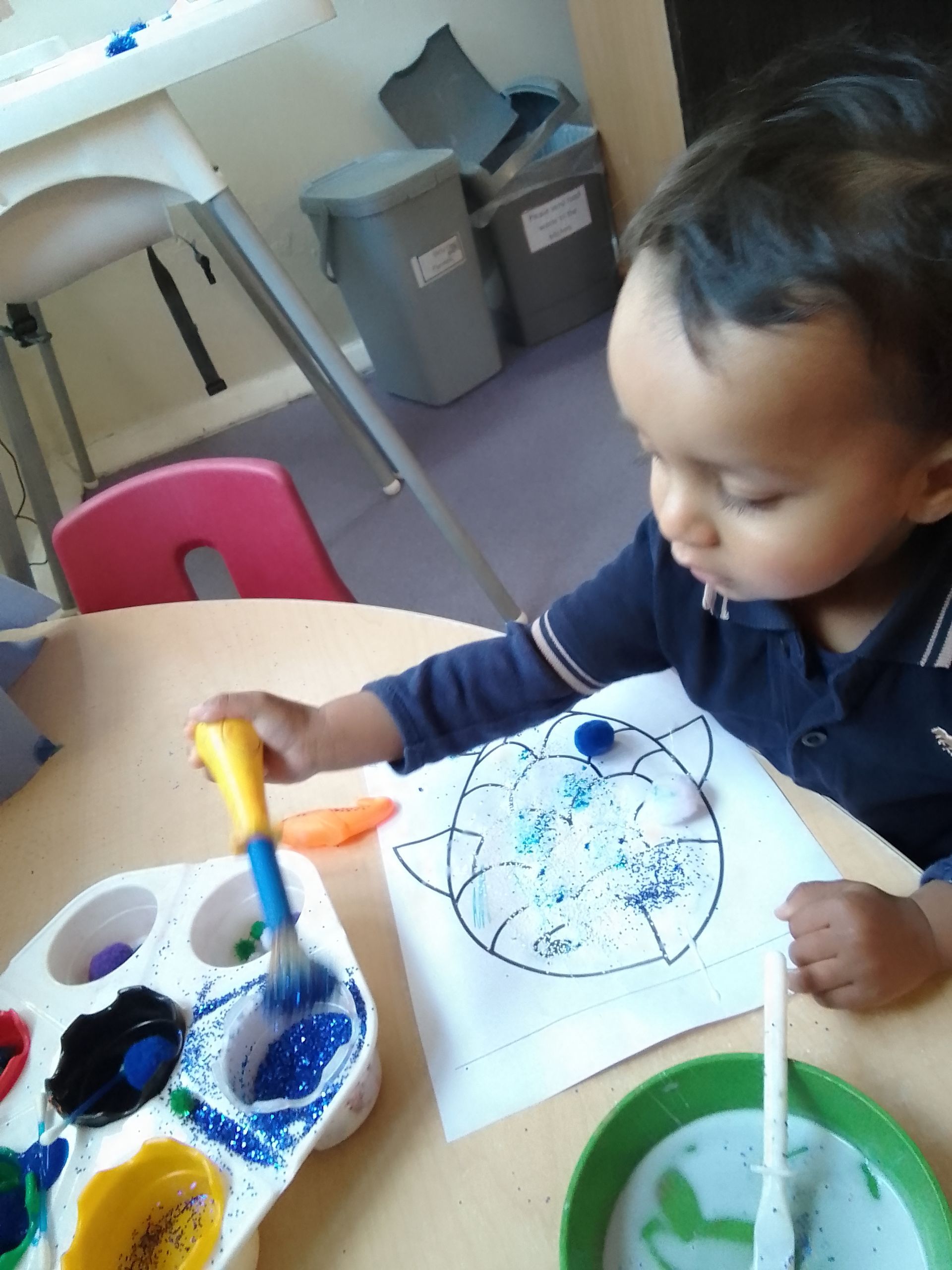 A child is painting a picture of a cat on a piece of paper Gingerbread