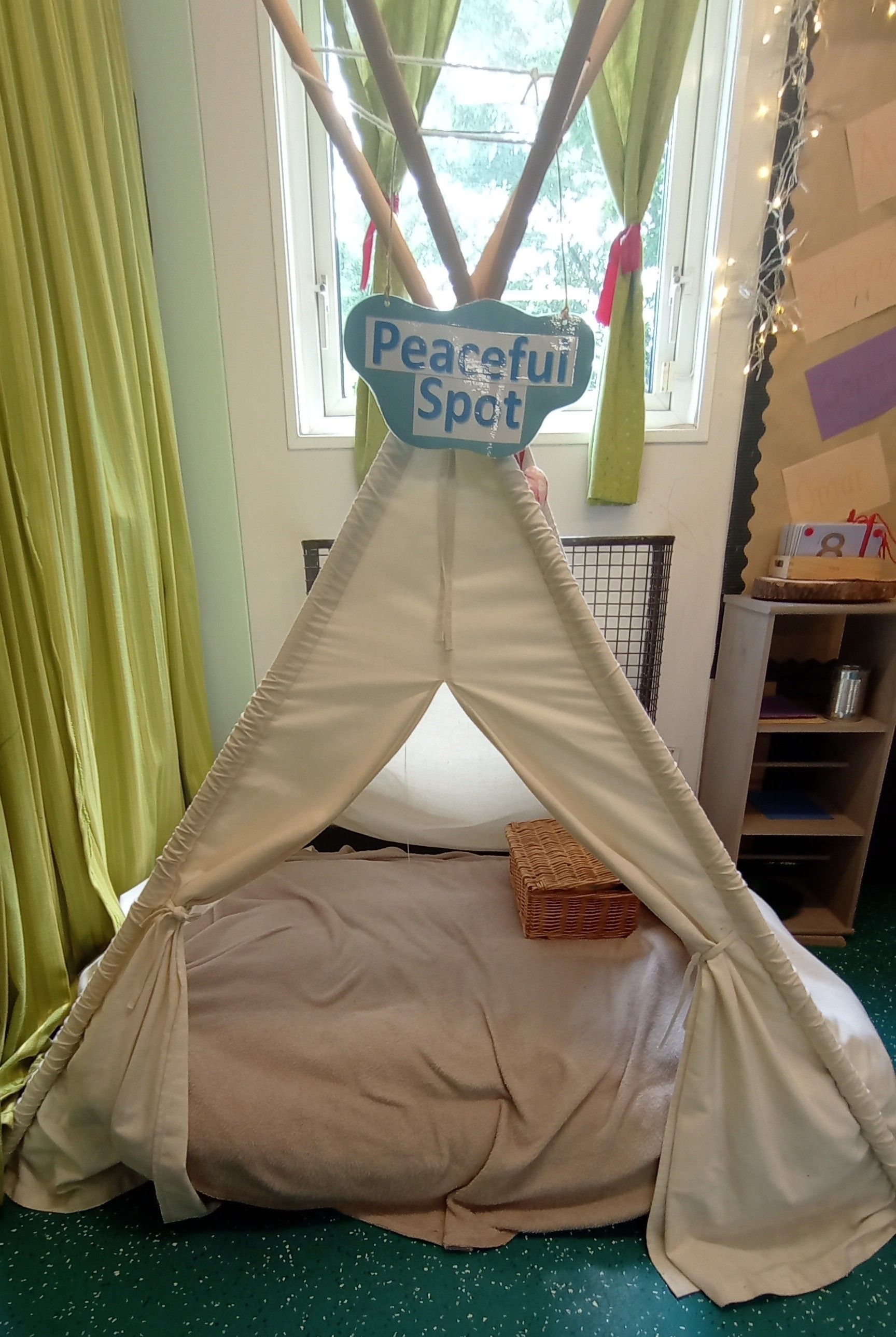 A teepee in a room with a sign that says peaceful spot. Gingerbread