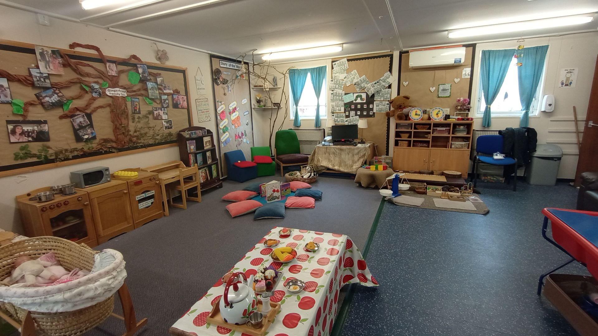 A large room with a table and chairs in it. Gingerbread