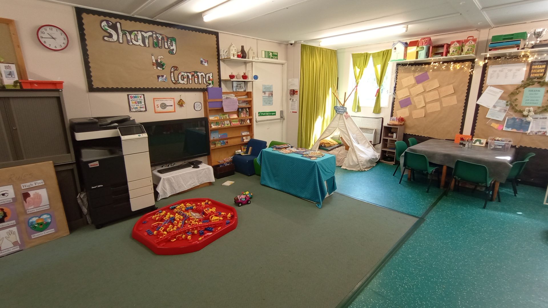 A classroom with a lot of furniture and a clock on the wall. Gingerbread