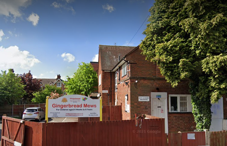 A brick building with a sign that says gingerbread mews on it.