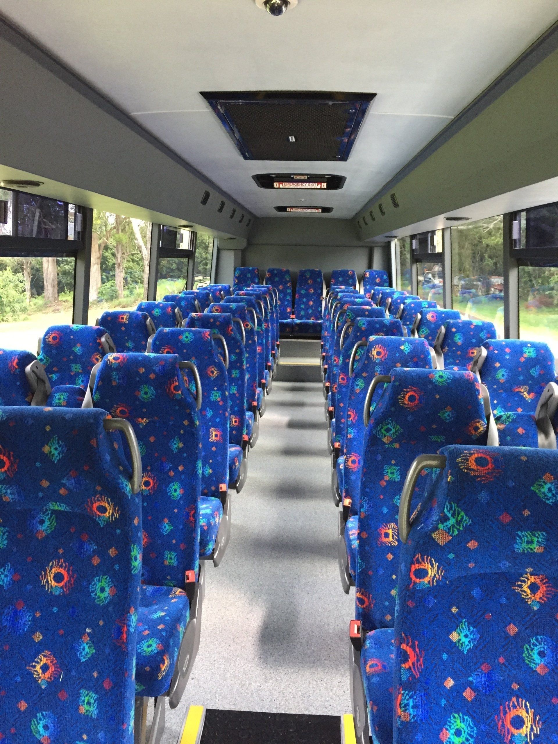 Inside of the bus with blue seats