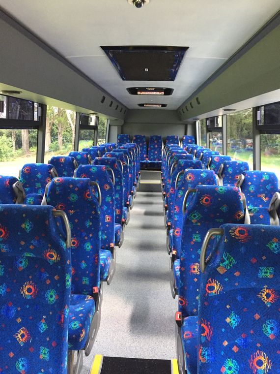 Inside of the bus with blue seats