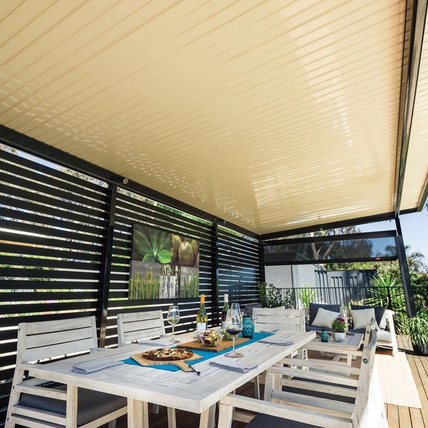 A patio with a table and chairs under a canopy
