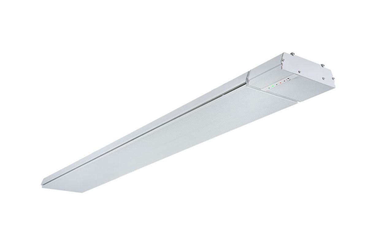A long white light fixture is sitting on top of a white surface.