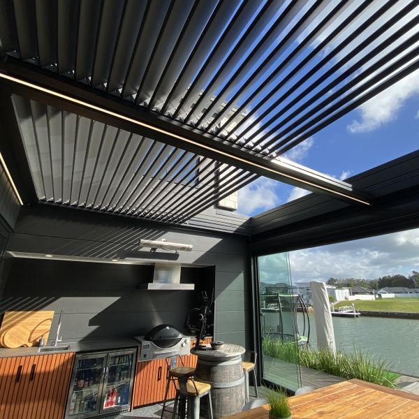 A kitchen with a large window and a pergola over it