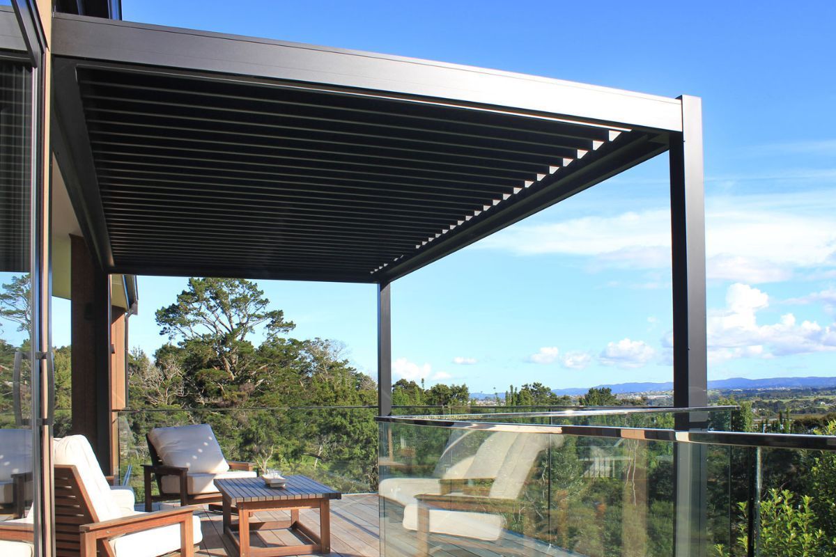 A balcony with a pergola and a view of the mountains