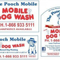 A bunch of signs for a mobile dog wash.
