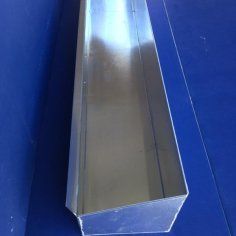 A metal box is sitting on top of a blue table.