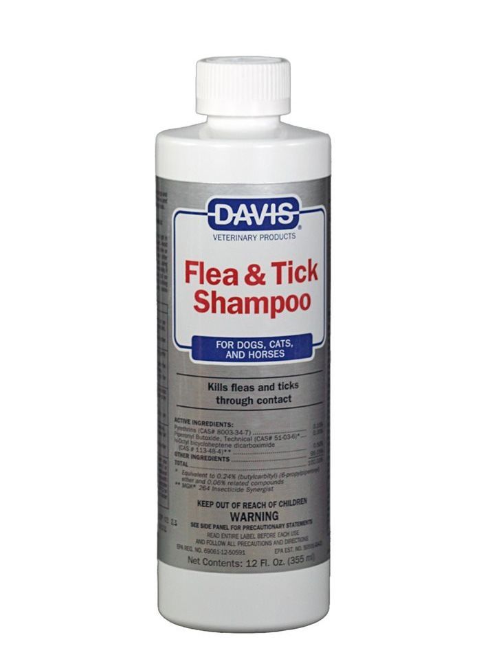 A bottle of davis flea and tick shampoo on a white background
