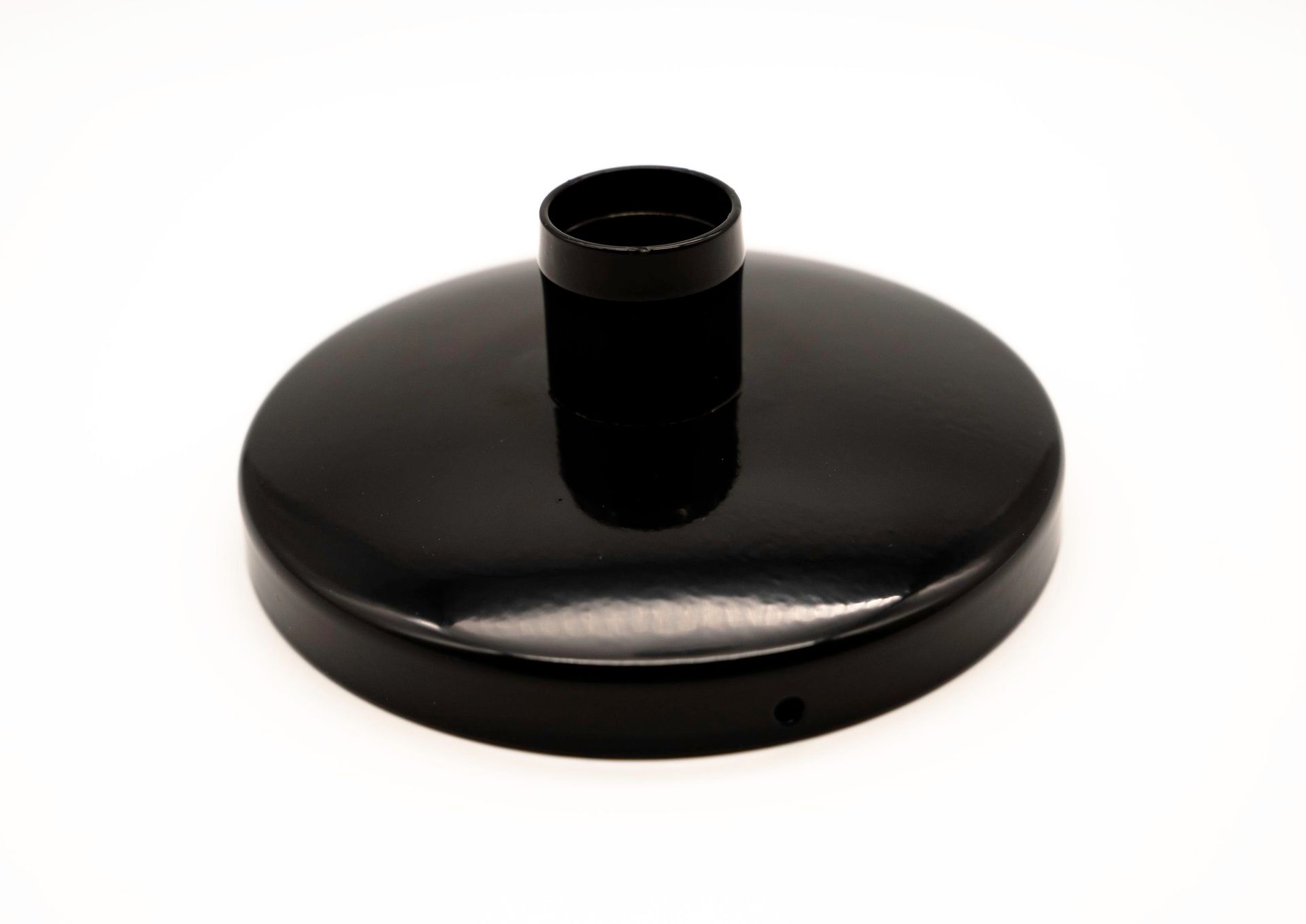 A black round object with a hole in the middle