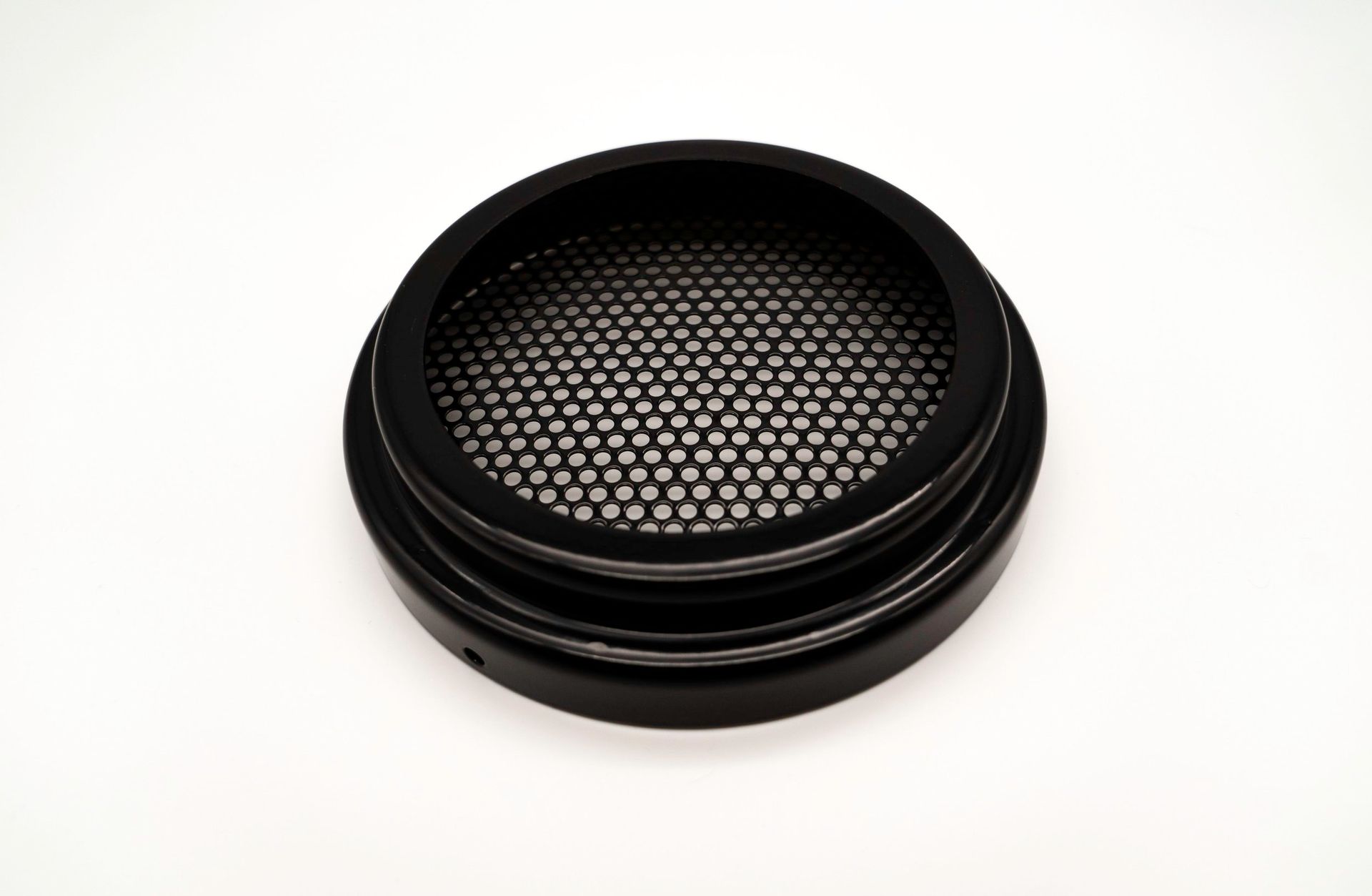 A black circle with holes in it on a white background