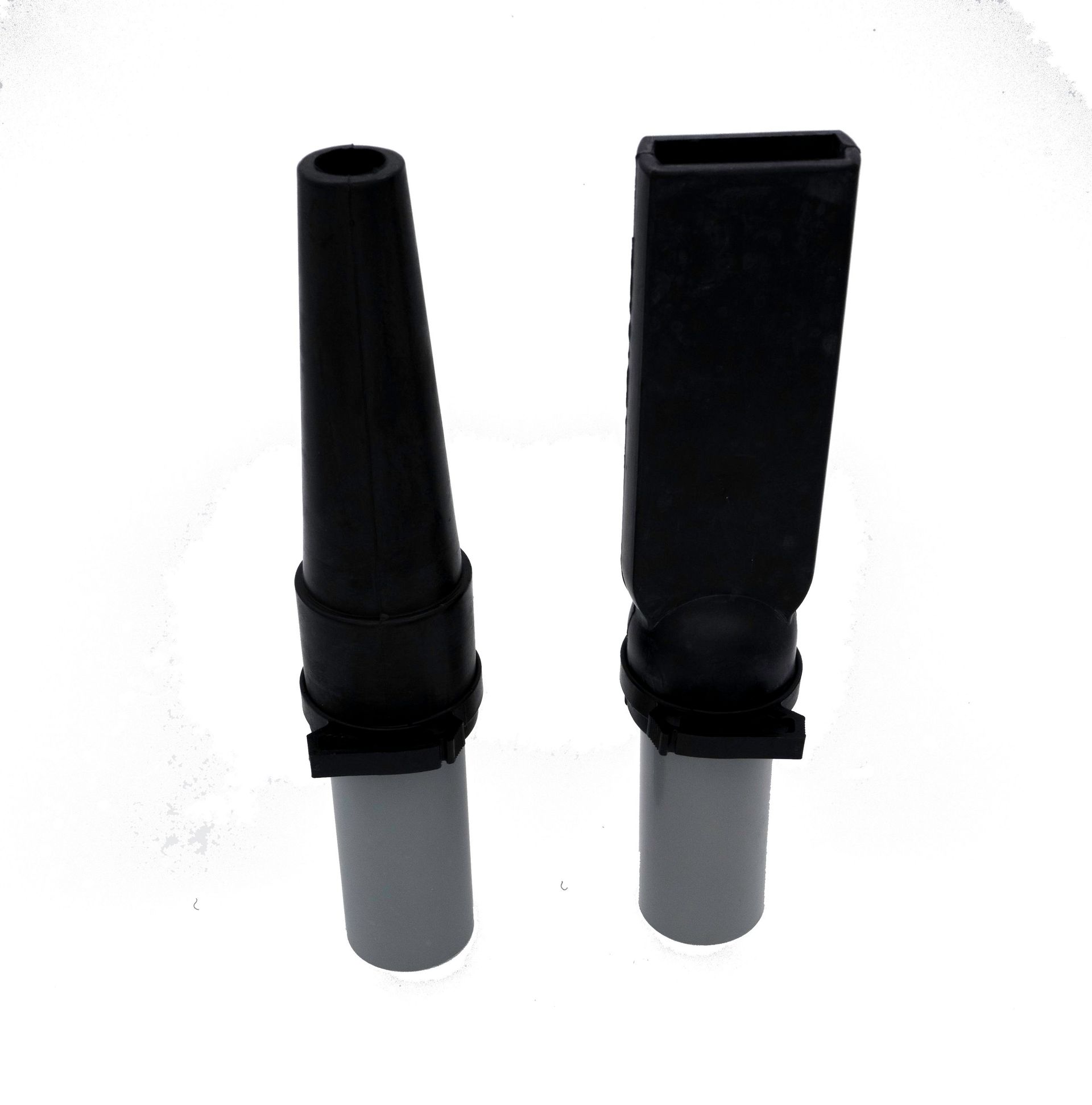 Two black tubes are sitting next to each other on a white surface.