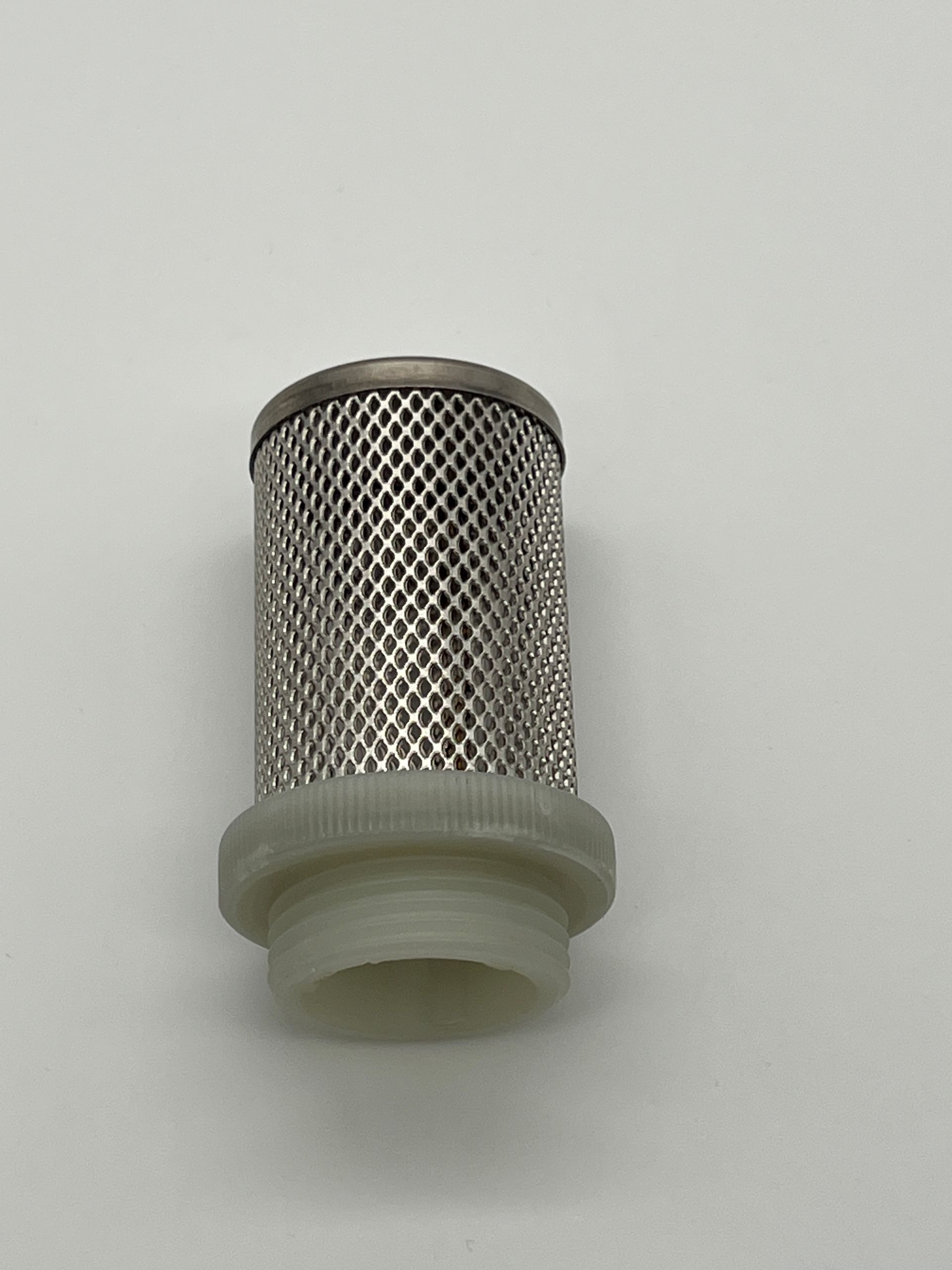 A stainless steel filter is sitting on a white surface.
