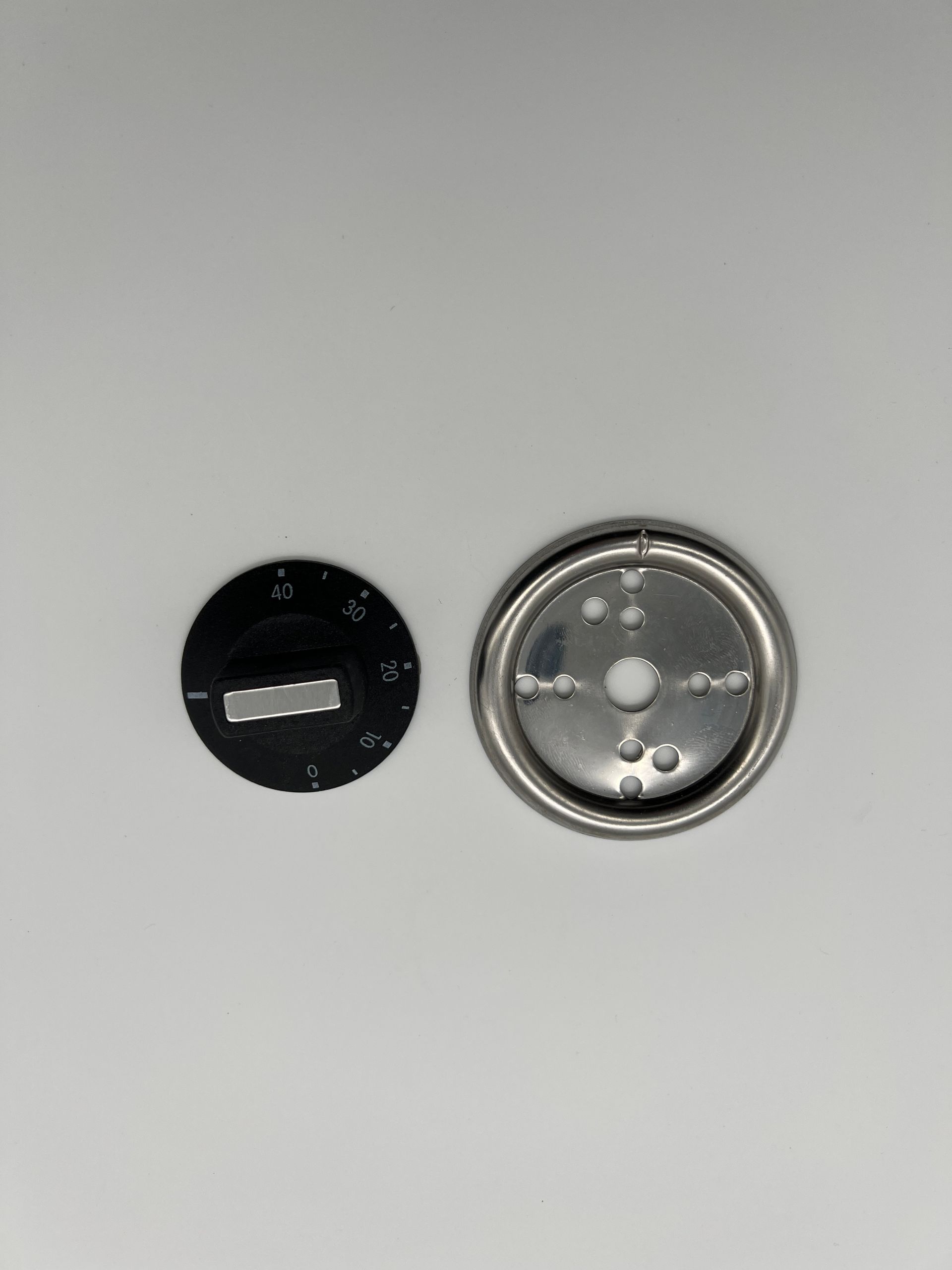 A close up of two buttons on a white surface.