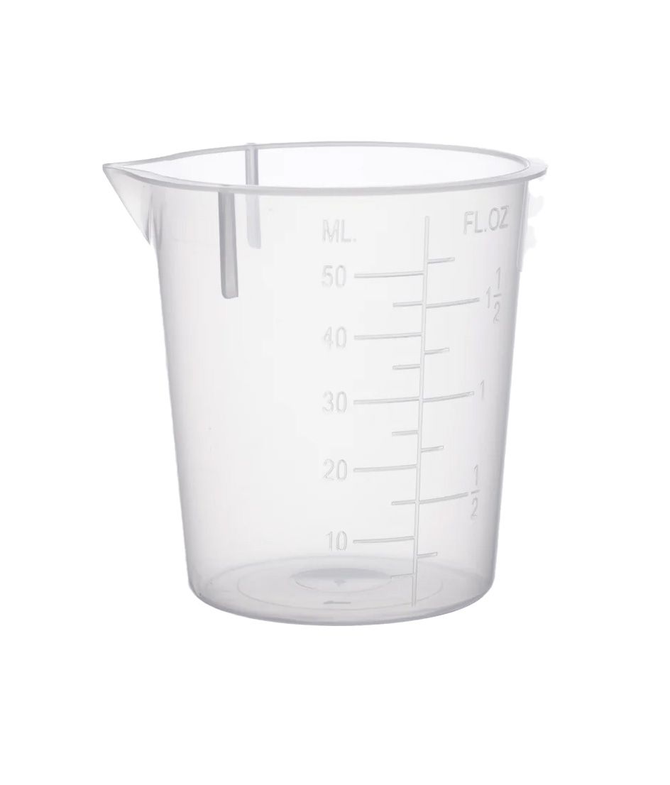 A clear plastic measuring cup with measurements on it on a white background.