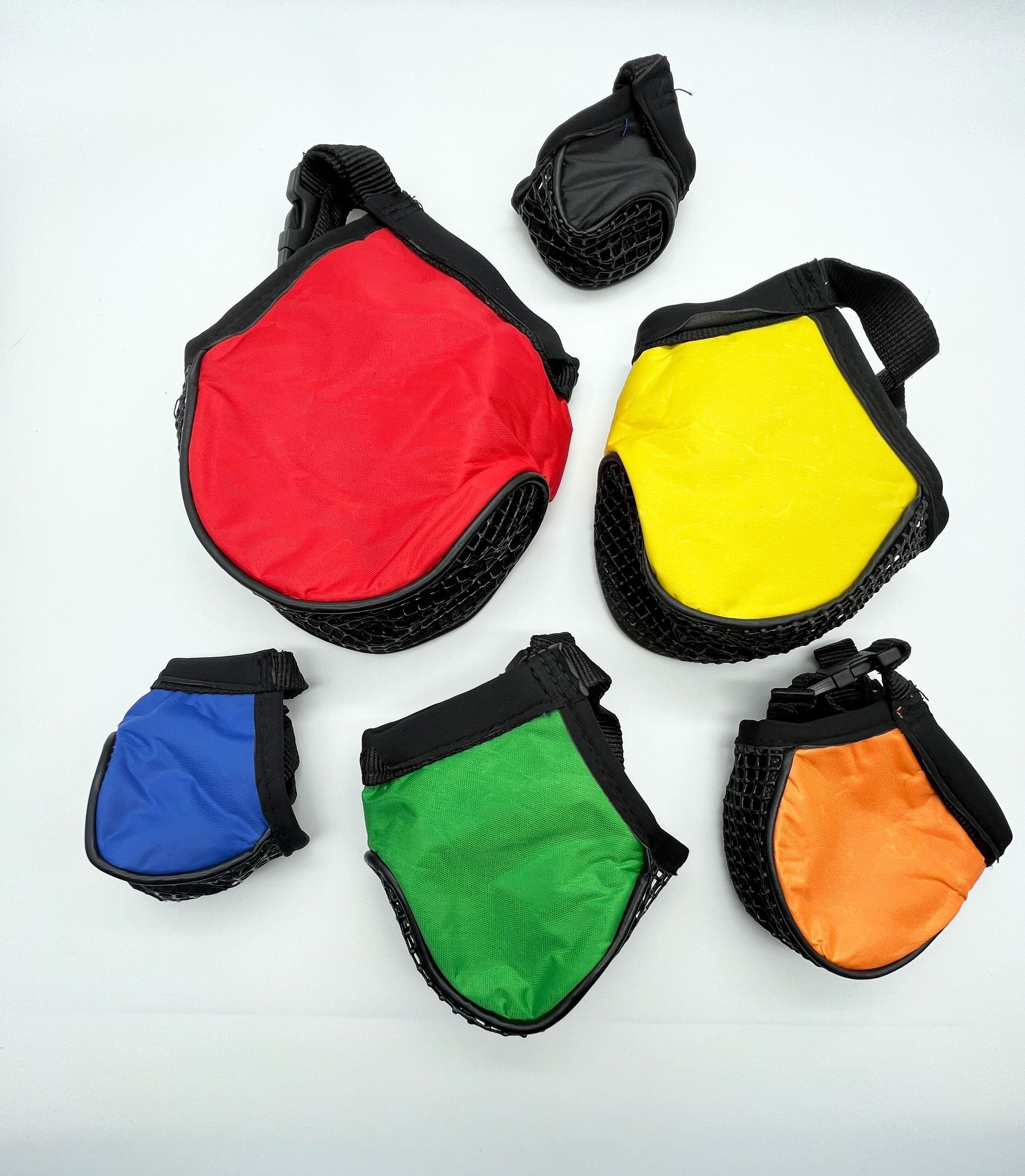 A bunch of different colored bags on a white surface
