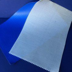 A piece of white fabric is sitting on top of a blue surface.