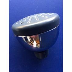 A close up of a metal object on a blue surface.