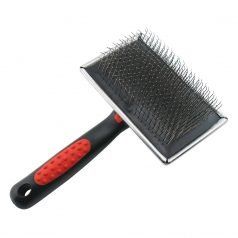 A black and red brush with a red handle on a white background.