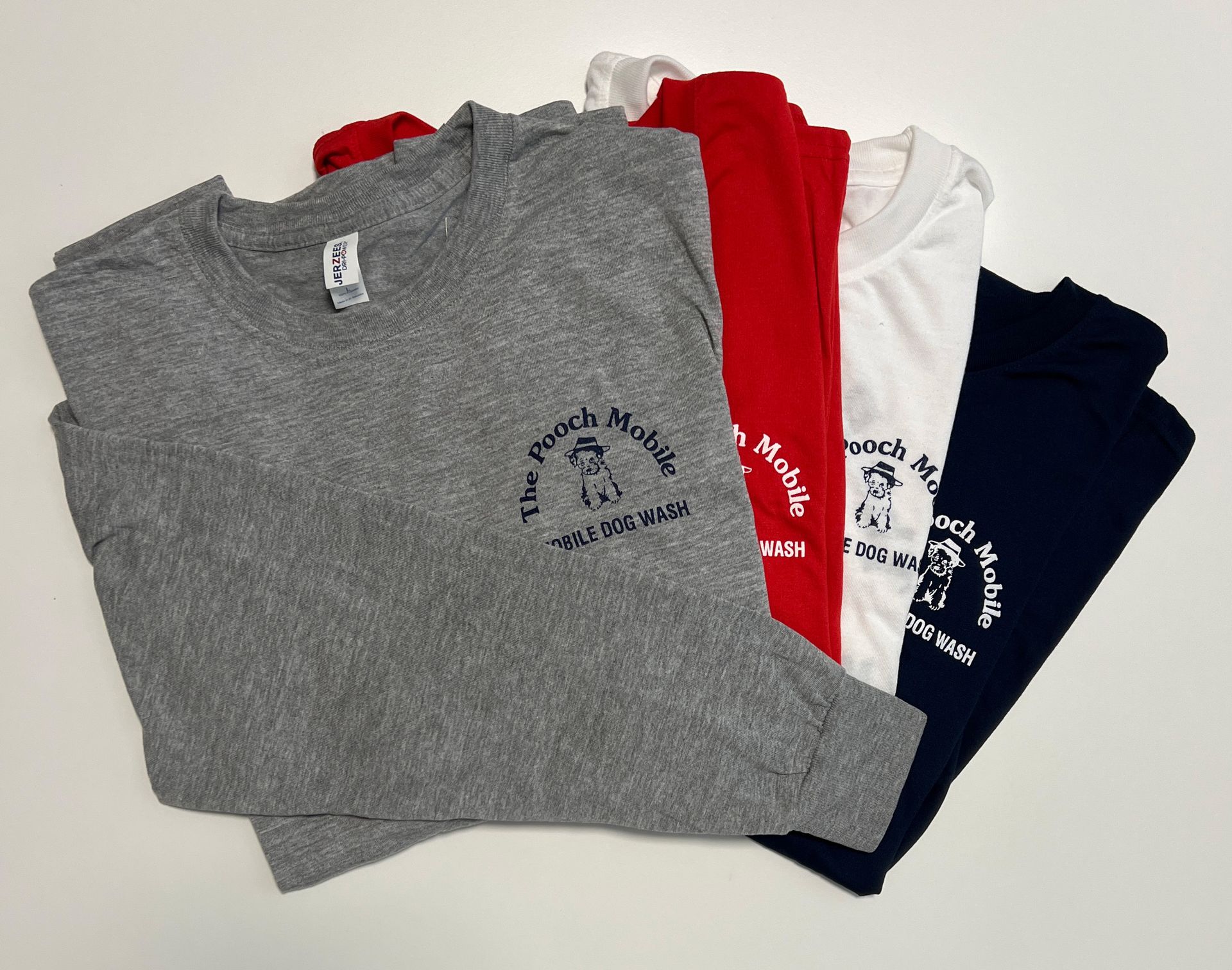 A bunch of long sleeve t-shirts are stacked on top of each other