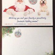 A christmas card with santa claus and a dog on it.