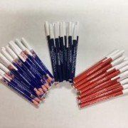 A bunch of pencils are sitting on top of each other on a table.