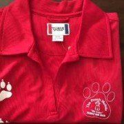A red polo shirt with a paw print on it.