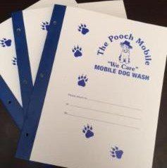 A bunch of notebooks sitting on top of each other on a table.