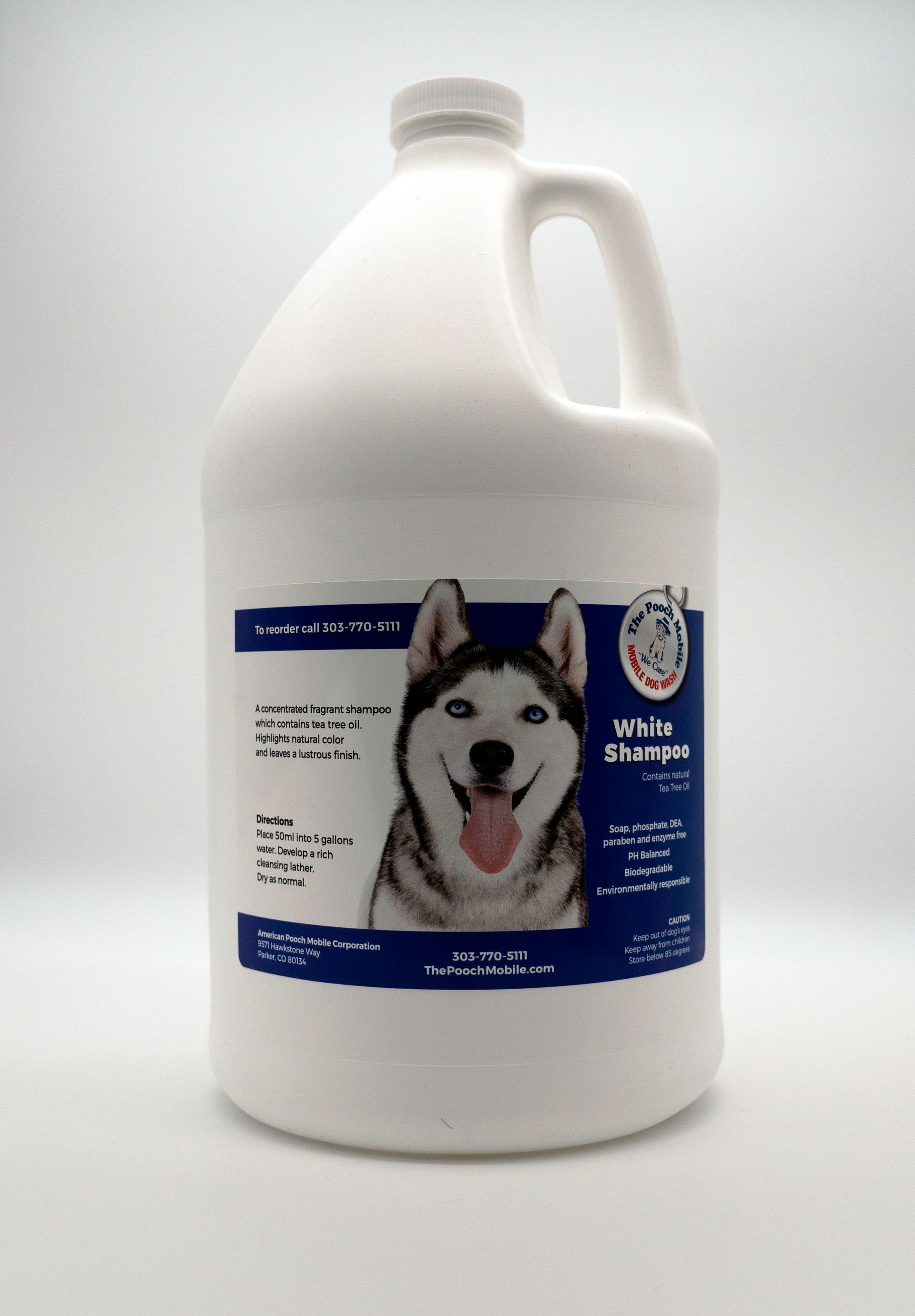 A gallon of white shampoo with a picture of a husky on the label