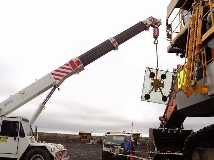 A Large Crane Is Lifting A Large Piece Of Glass — Australian Specialised Machinery Glass In Mount Louisa, QLD