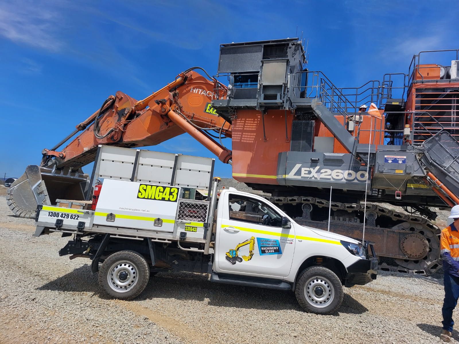 A Bulldozer Is Parked Next To A Van In A Field — Australian Specialised Machinery Glass In Mount Louisa, QLD