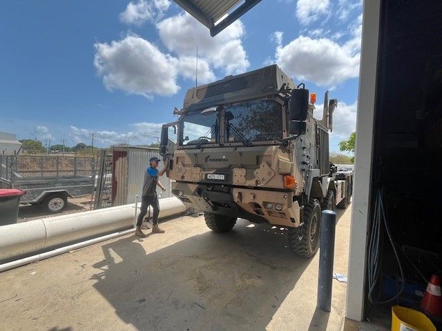 A Row Of Trucks Are Parked In A Parking Lot — Australian Specialised Machinery Glass In Mount Louisa, QLD