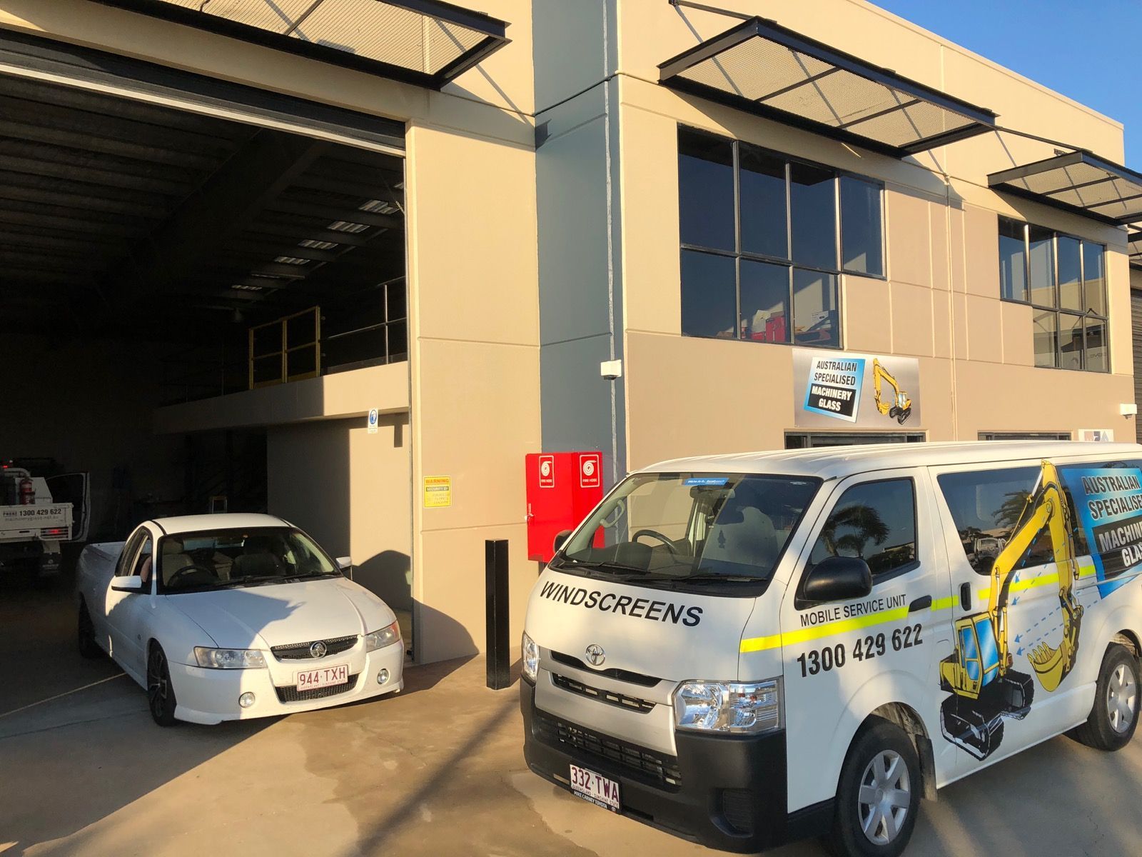 A Truck with a Crane Attached to it is Parked on a Dirt Road — Australian Specialised Machinery Glass In Mount Louisa, QLD