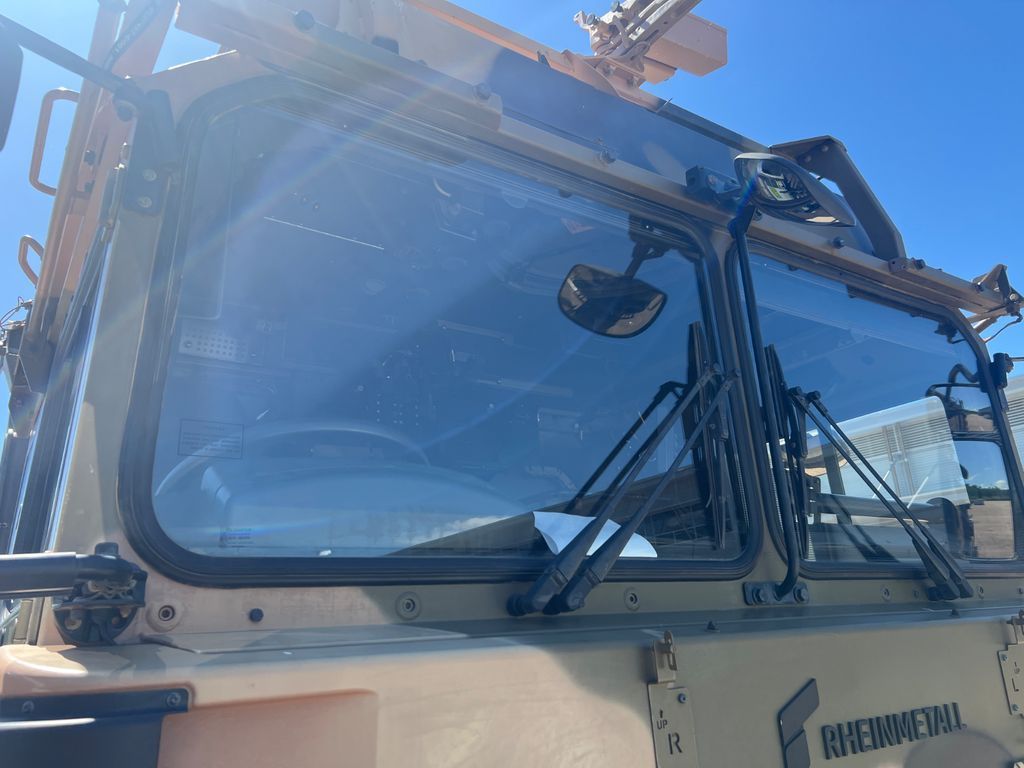 A Man Is Installing A Windshield On A Car — Australian Specialised Machinery Glass In Mount Louisa, QLD