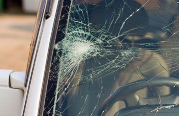 Cracked car windshield from the inside. White car, spiderweb pattern of broken glass. - Australian Specilased Machinery Glass, QLD