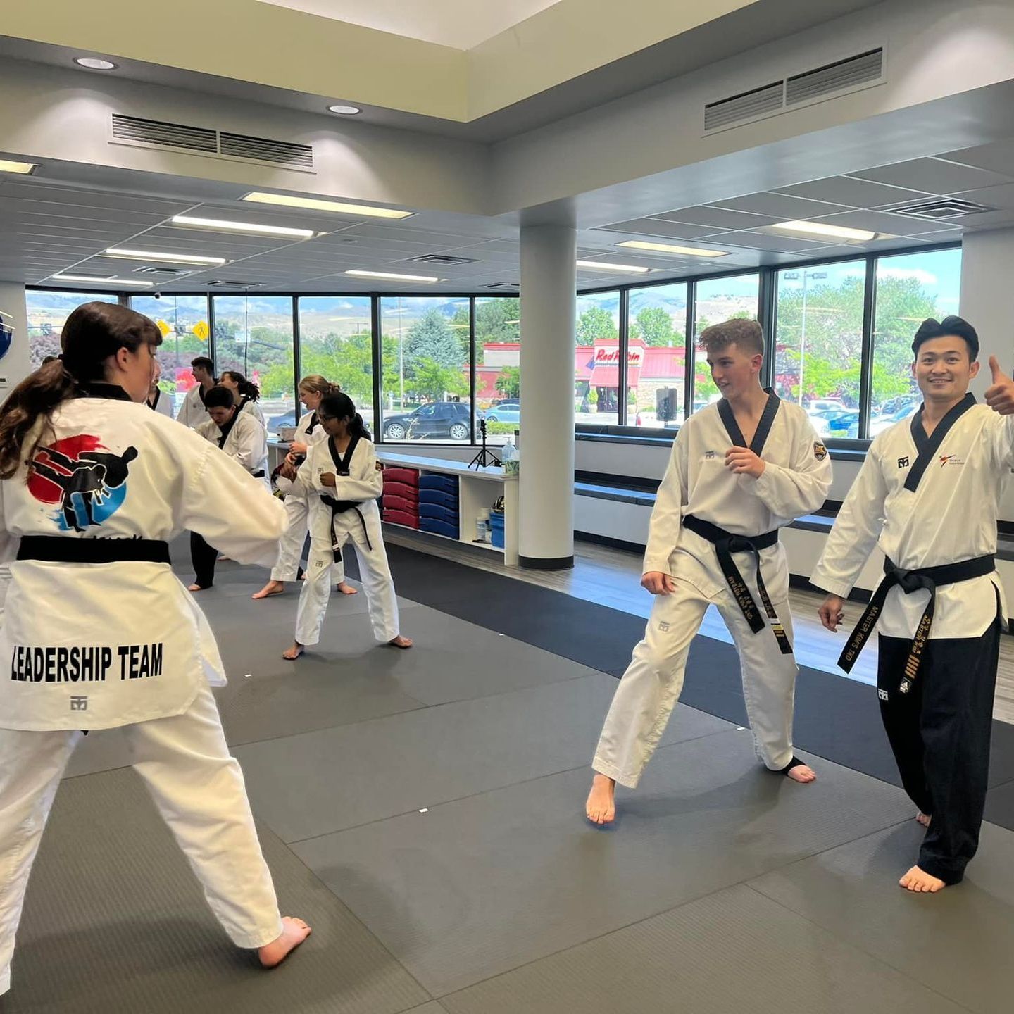 Two young men are practicing karate on a mat