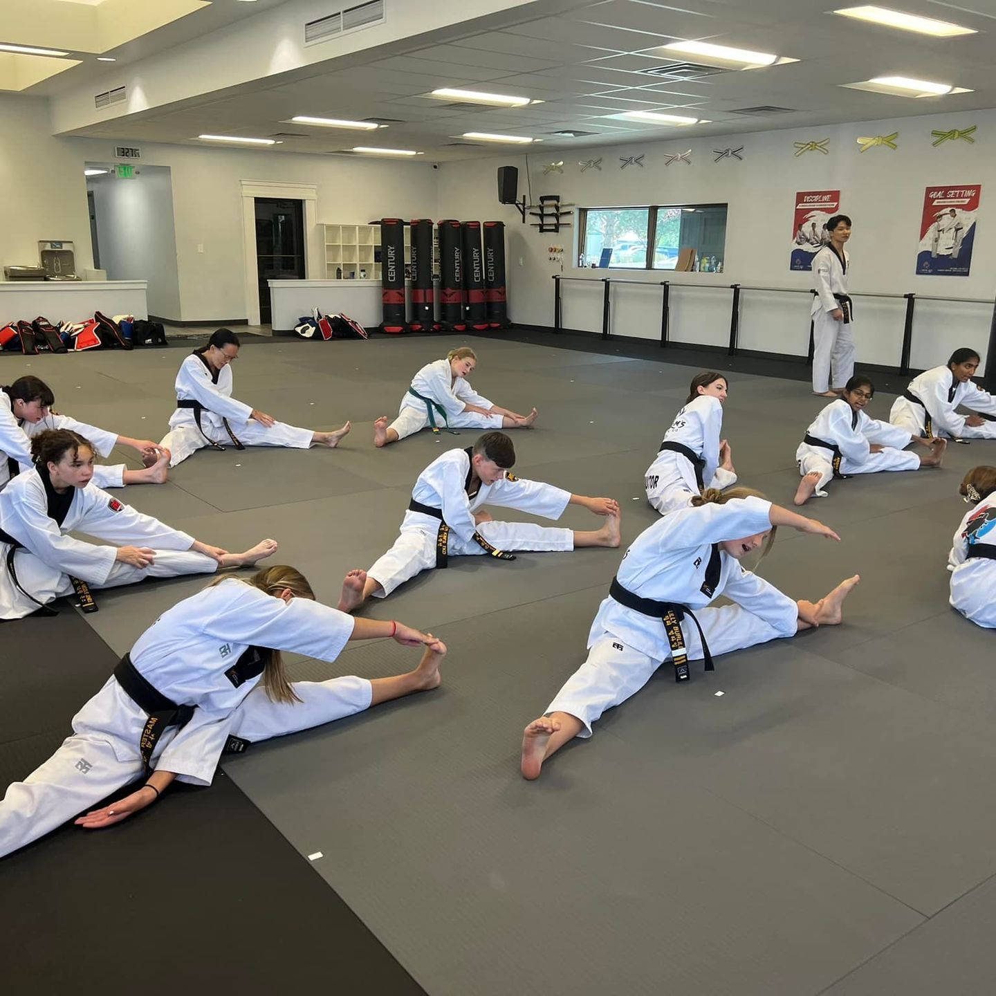 A group of men are practicing karate in a gym.