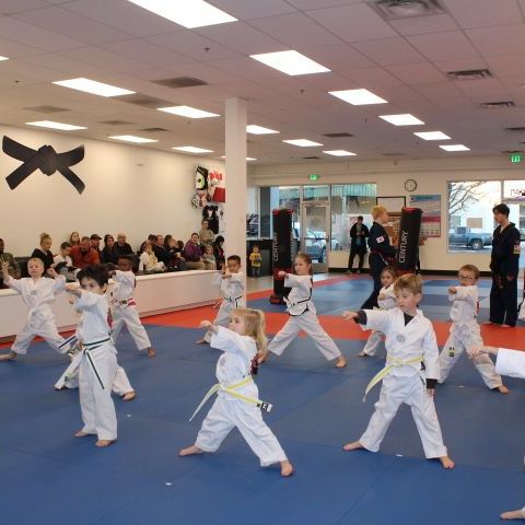 A boy and a girl are practicing taekwondo together.