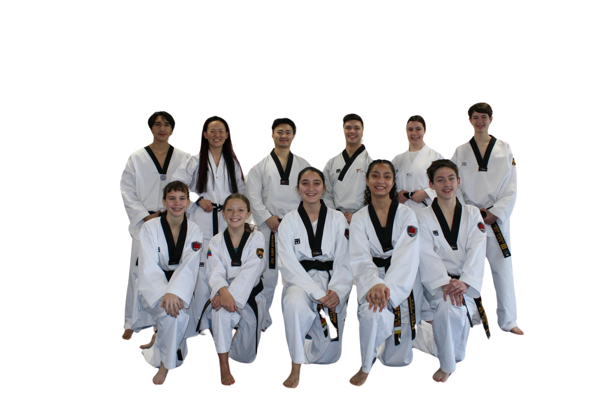 A man and a woman are standing next to a young boy in karate uniforms