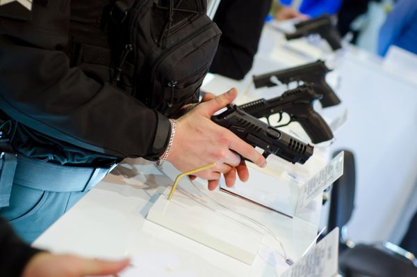 Man Holding a Pistol on Shop — Tucson, AZ — Murphy's Guns And Gunsmithing