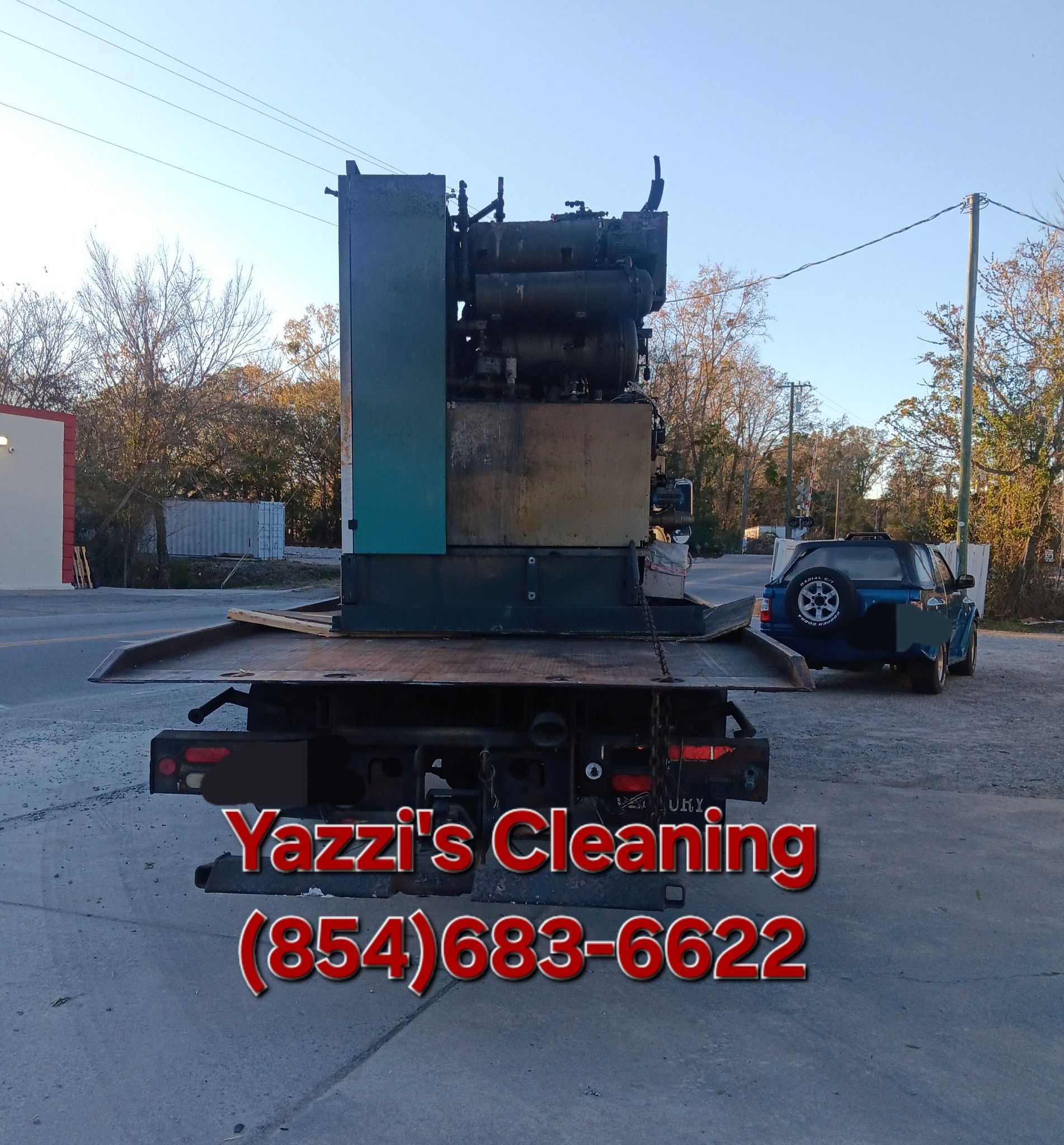 Paint cans and painting supplies in a room under renovation: roller, brush, tray, cord reel.